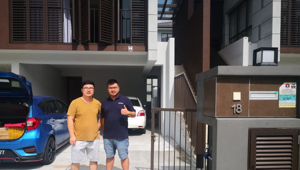 Customers in front of their home after auto gate and camera installation